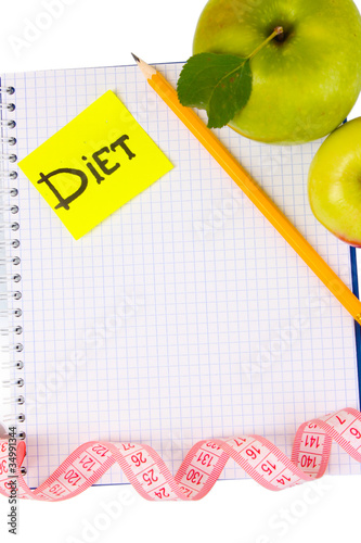 Planning of a diet. Notebook, pencil and fresh apples