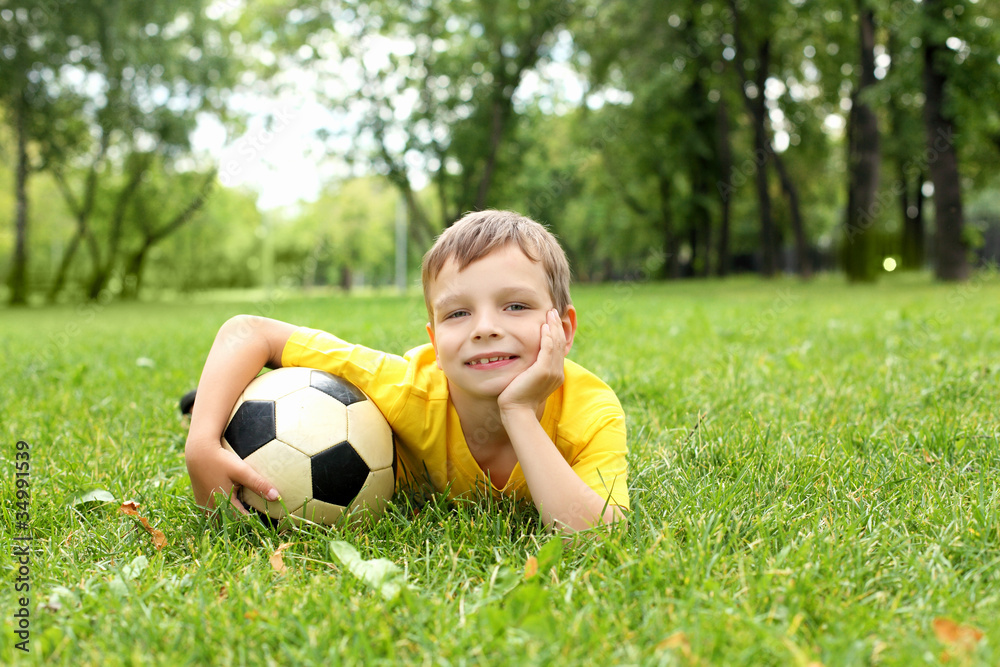 Obraz premium Little boy in the park with a ball