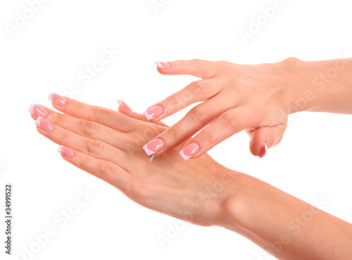 Closeup of beautiful female hands applying hand cream