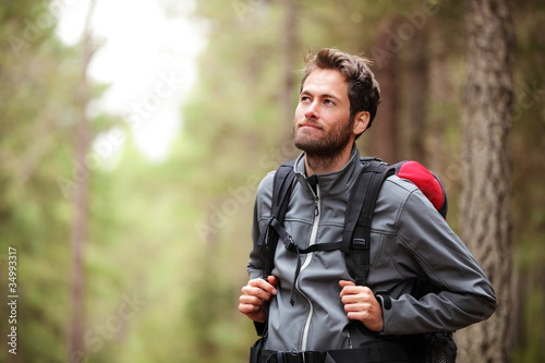Hiker - man hiking in forest