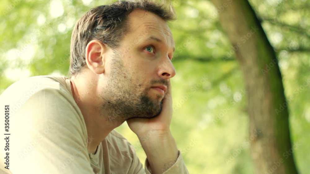 Young, sad, lonely man in the park