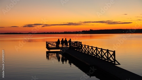 People on the pier at sunset