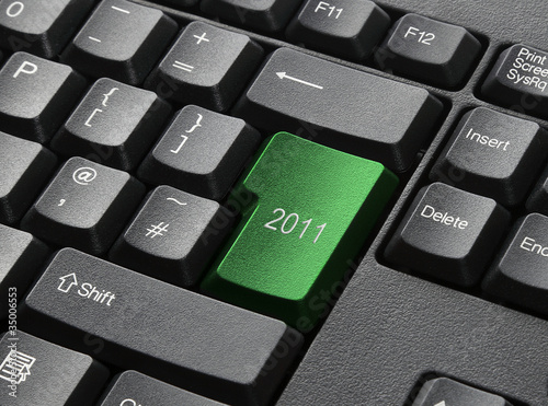 A Black Keyboard With Green Key Labelled 2011