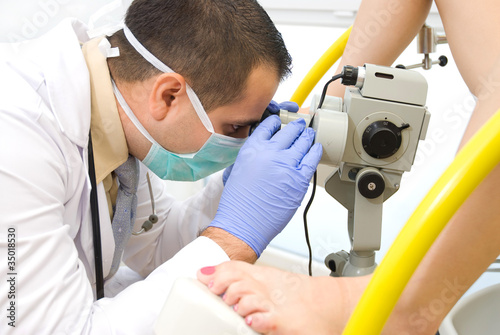 Gynecologist examining a patient a colposcope