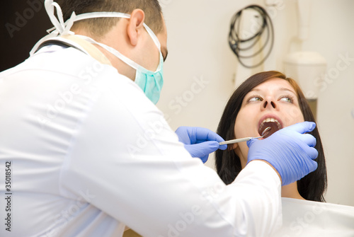 Image of a dentist curing a girl s teeth