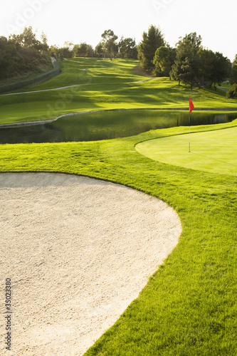 Sand trap and pond on golf course