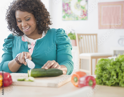 African American woman slicing vegetables