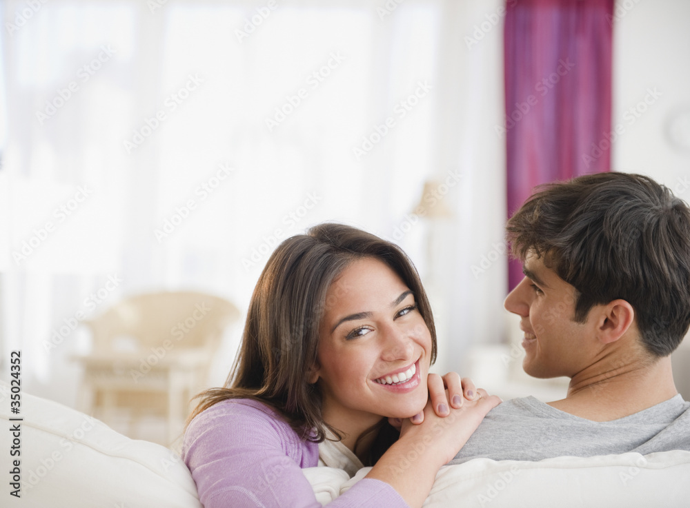 Smiling sitting together on sofa Smiling sitting together on sofa