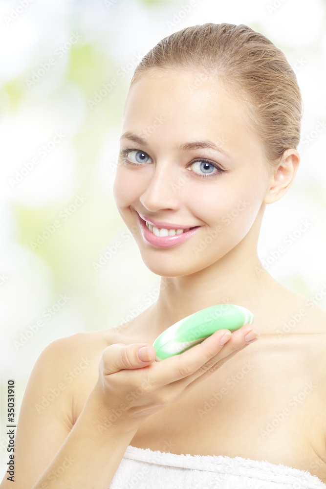Smiling girl holding soap