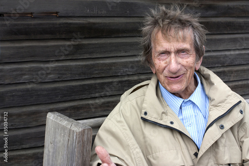 elderly retired man looking and laughing at camera photo