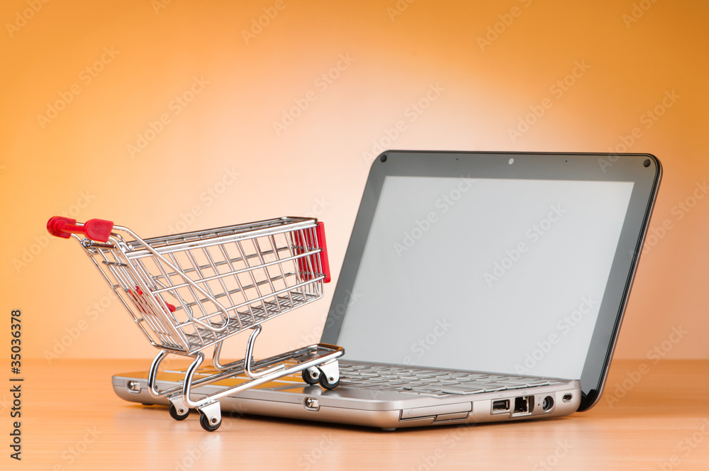 Internet online shopping concept with computer and cart Internet online shopping concept with computer and cart