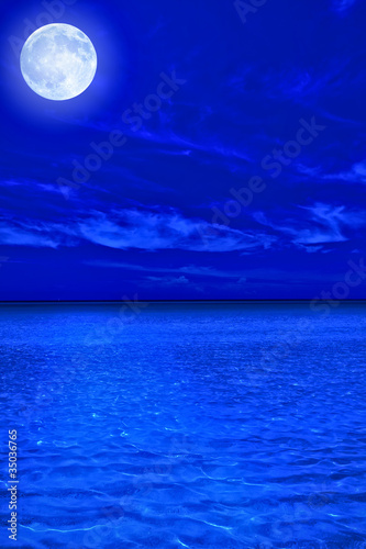 Ocean at midnight with a bright full moon