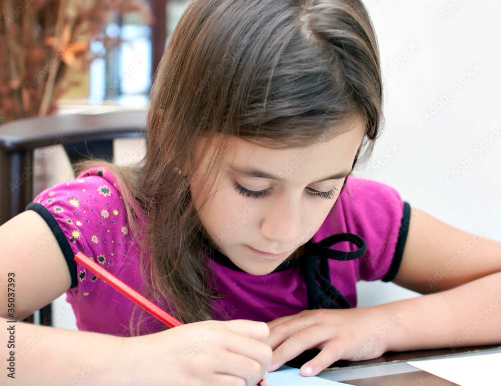 Adorable latin girl working on her homework Adorable latin girl working on her homework