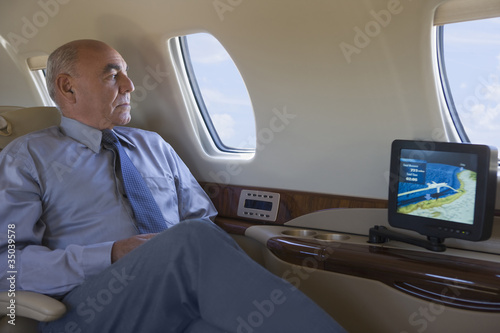 Hispanic businessman on private jet photo