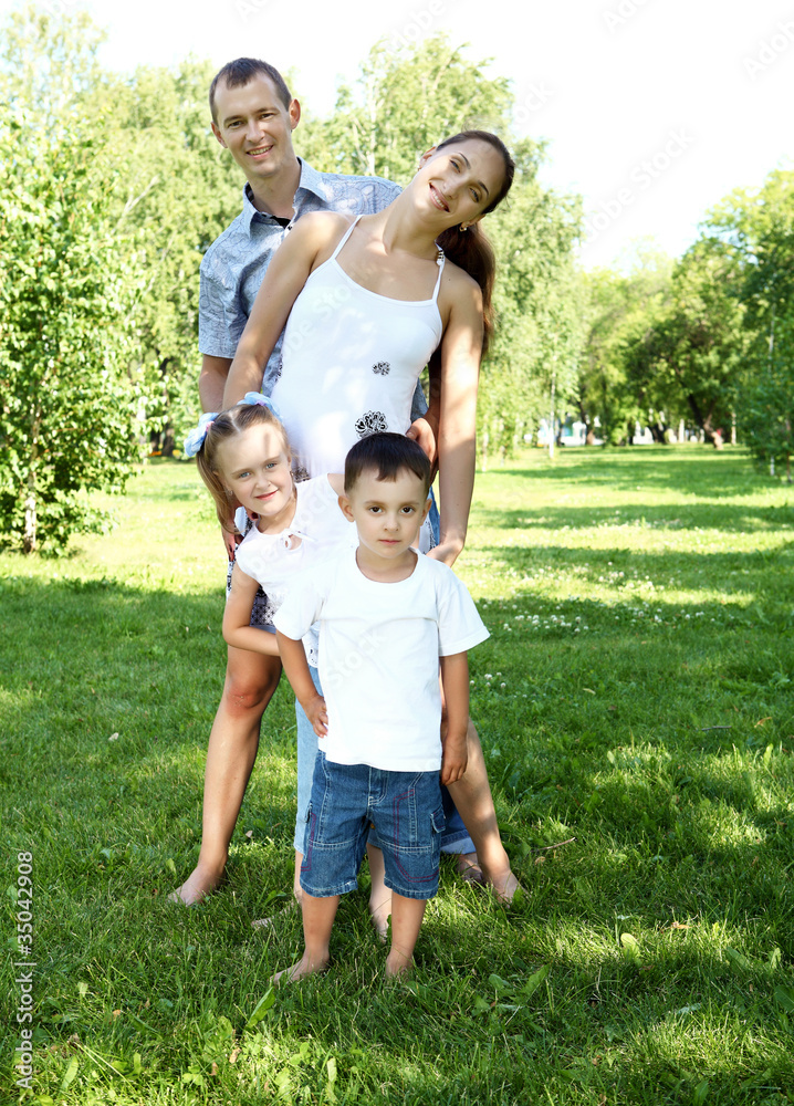 Fototapeta premium Family with two children in the summer park