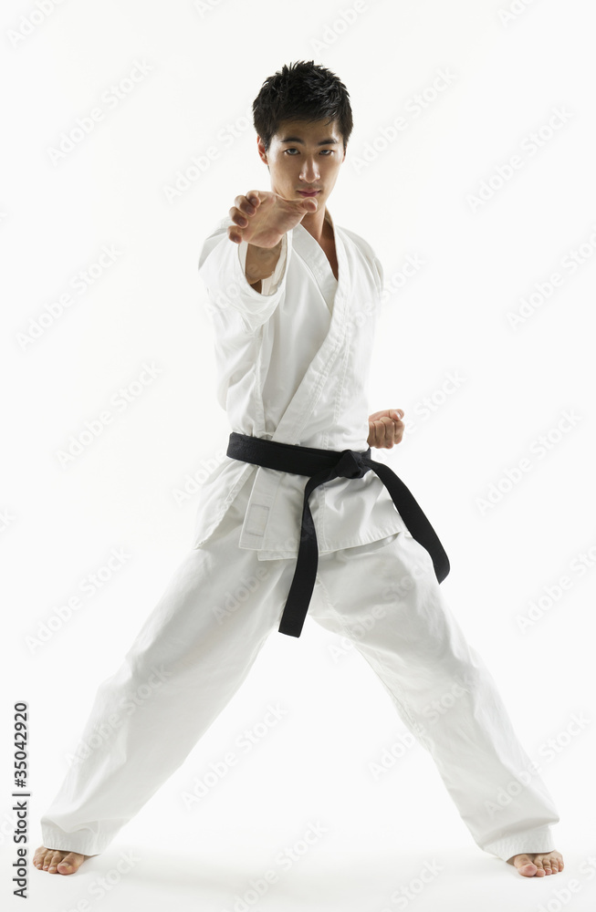 Asian male black belt practicing karate Asian male black belt practicing karate