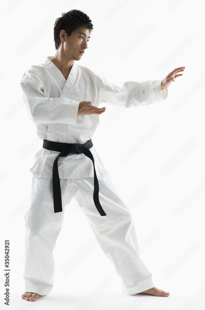 Asian male black belt practicing karate Asian male black belt practicing karate