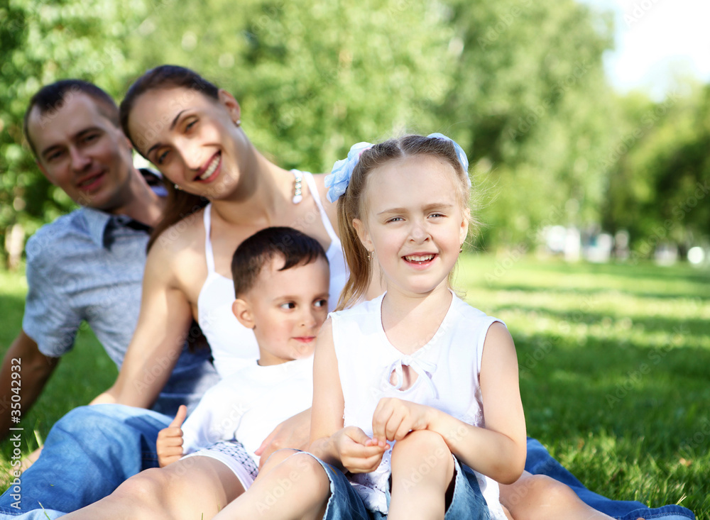 Family with two children in the summer park Family with two children in the summer park