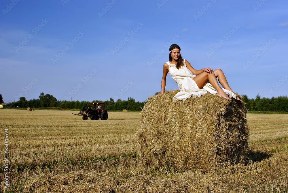 girl in a rural clothing sitting on the haystack girl in a rural clothing sitting on the haystack