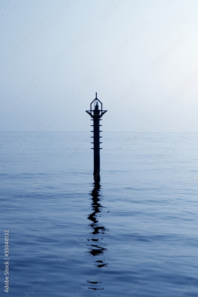 Obraz premium backlight beacon in Mediterranean blue sea reflection
