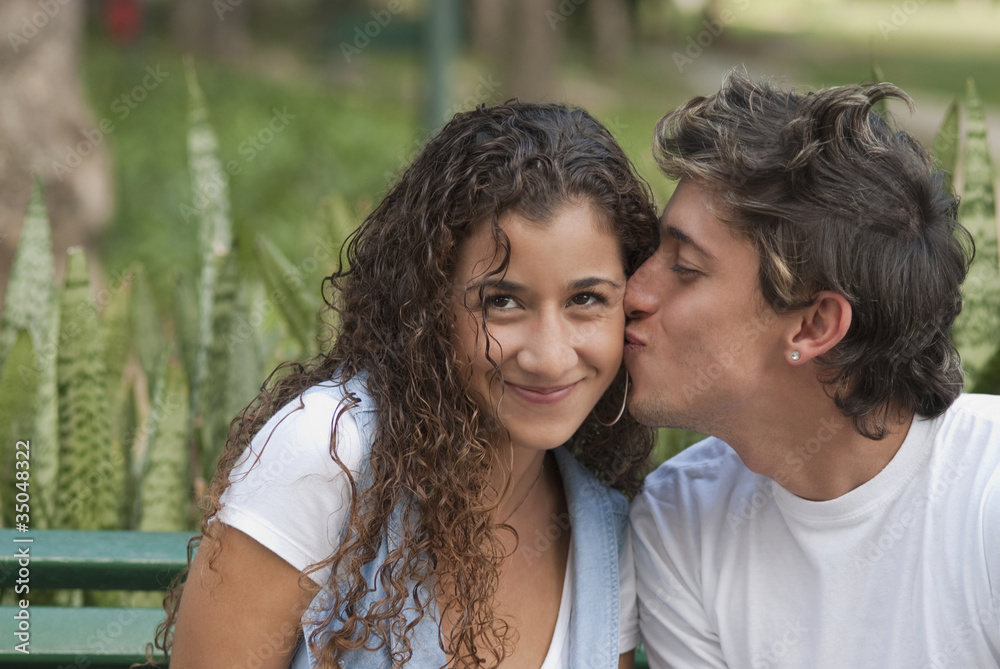 Hispanic man kissing girlfriend Hispanic man kissing girlfriend