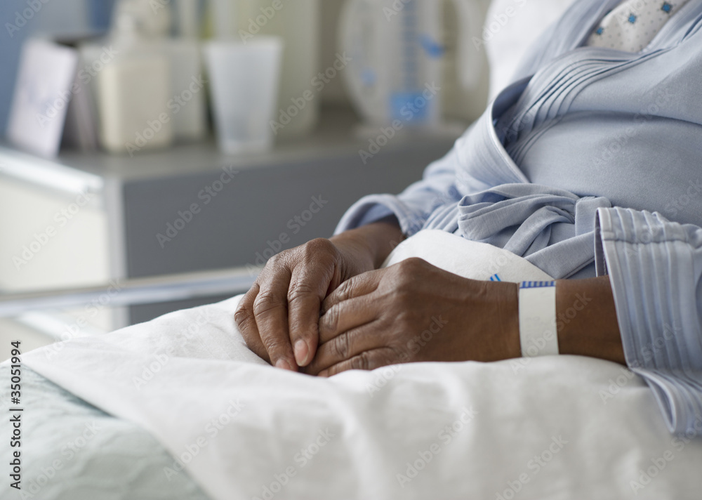 Black woman recovering in hospital bed Black woman recovering in hospital bed