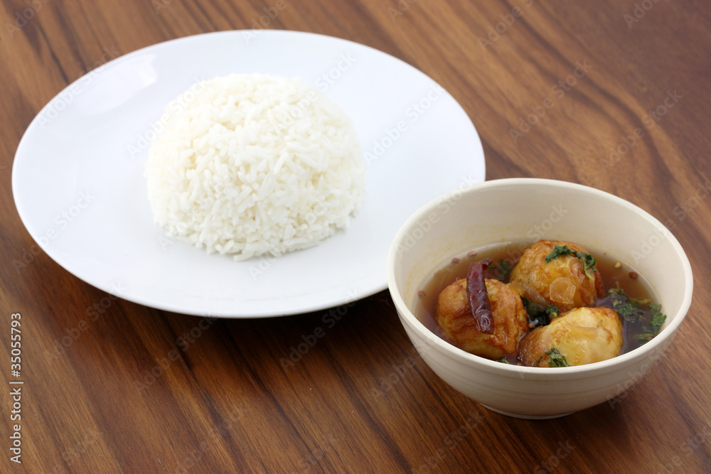 Thai food boiled egg fried with tamarind sauce and rice in wood Thai food boiled egg fried with tamarind sauce and rice in wood