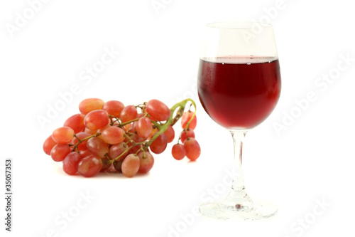 Red wine glass with grape isolated on white background