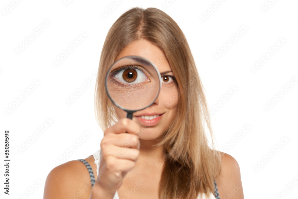 Close up of female looking throgh the magnifying glass Close up of female looking throgh the magnifying glass