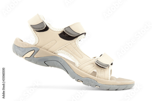 Side view of female travel sandal over white background