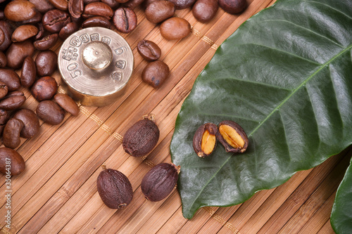 Roasted coffee beans and fruits with leafs