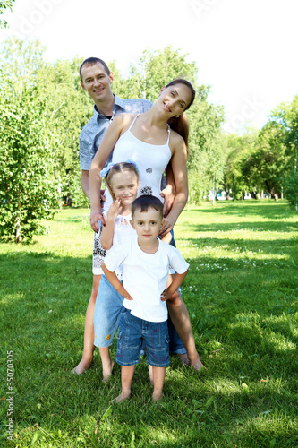 Family with two children in the summer park