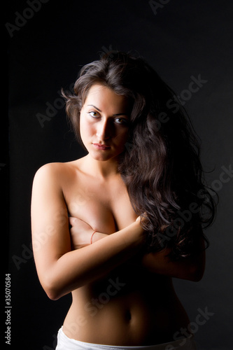 Young dark haired beautiful woman topless