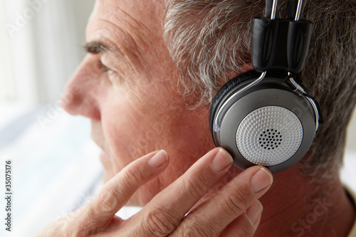 Mid age man wearing headphones photo