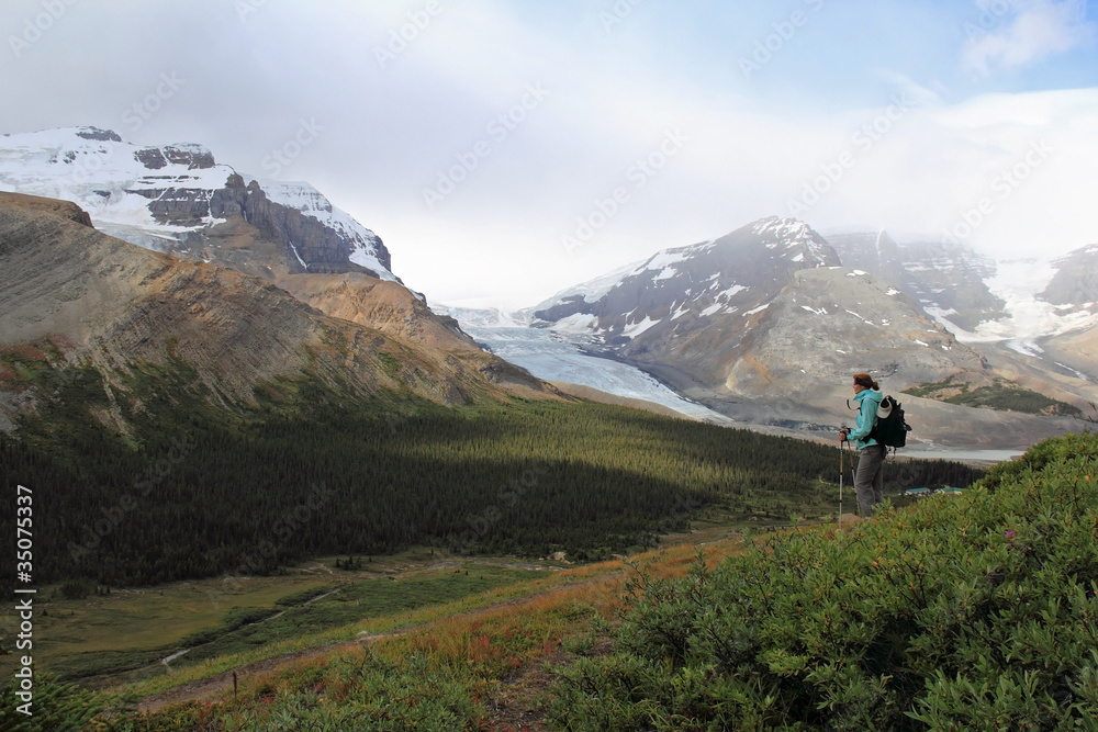 Hiker Looking Out Over Mountain Valley - Alberta, Canada