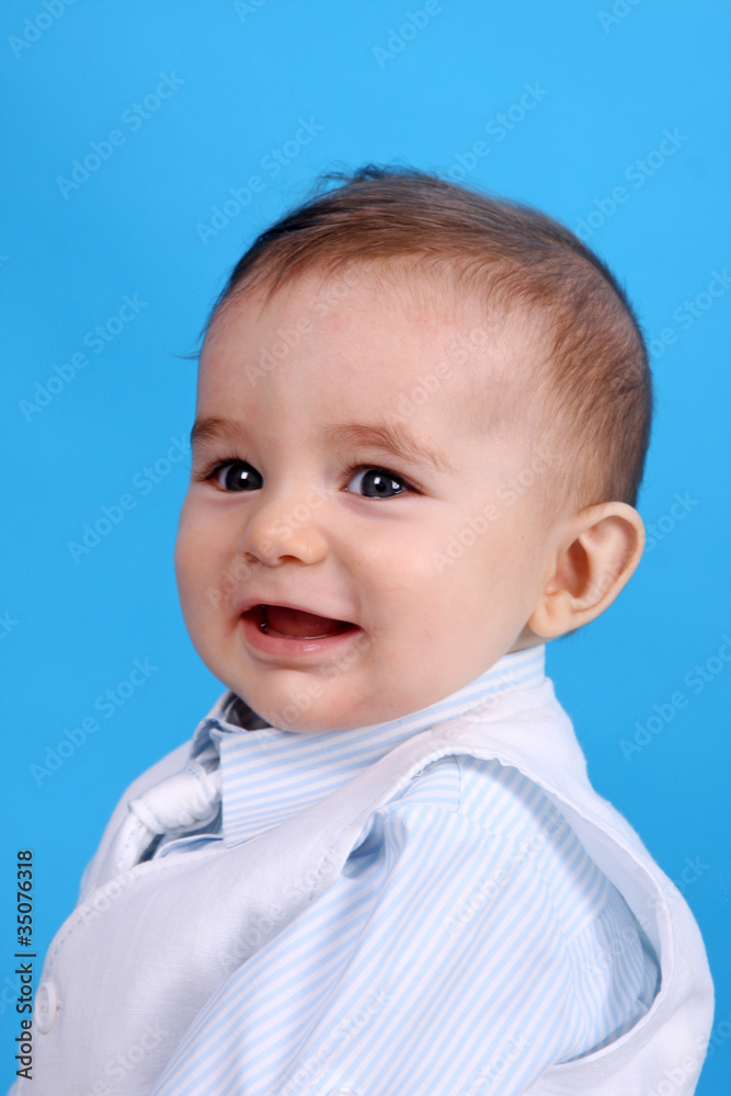 Portrait of a happy baby boy Isolated on blue background