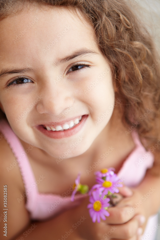 Young girl holding flowers