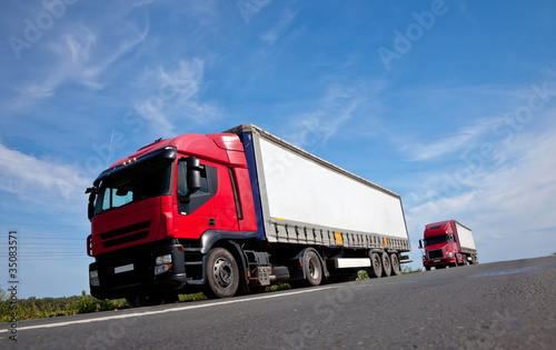 Two red trucks