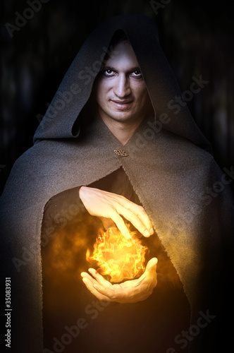 Obraz na plátně Halloween concept. Male wizard with fireball