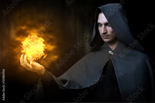 Halloween concept. Male wizard with fireball