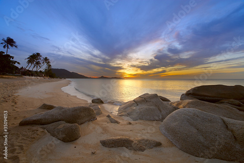 Sunrise at rocky coast of Lamai beach