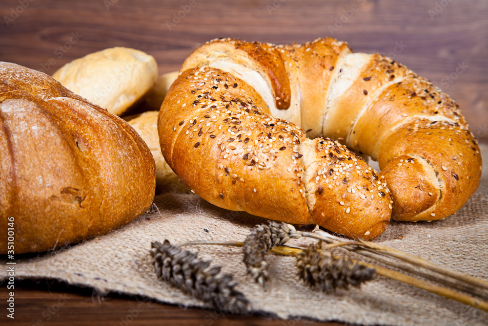 Composition of fresh bread on wood