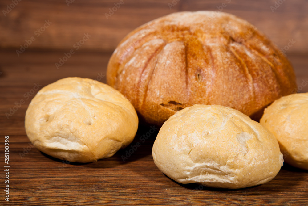 Composition of fresh bread on wood