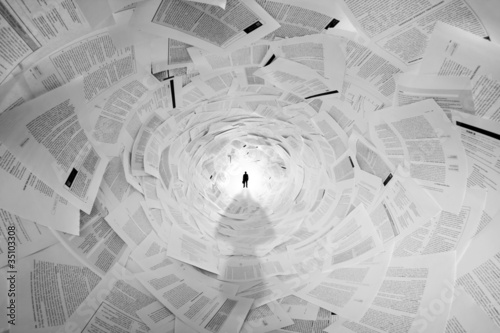Businessman in the end of documents tunnel