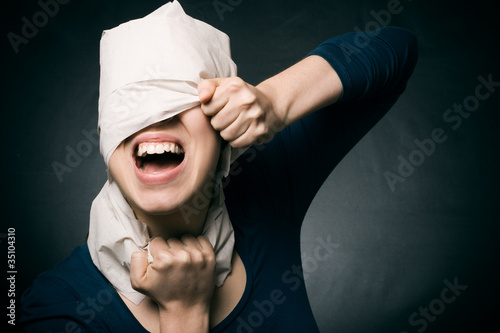 Fotografía Young woman's head wrapped in paper.