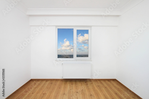 Small white room with sea view window photo