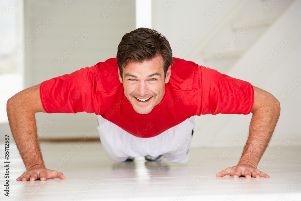 Man doing push-ups in home gym Man doing push-ups in home gym