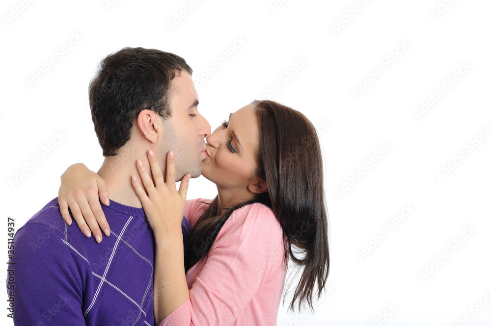 sweet young couple in love kissing. isolated sweet young couple in love kissing. isolated