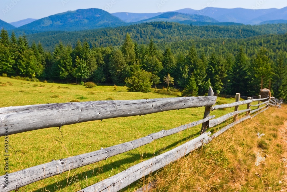 wooden fence on a mountain pasture
