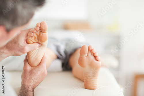 Foto Lying Woman getting a reflexology massage